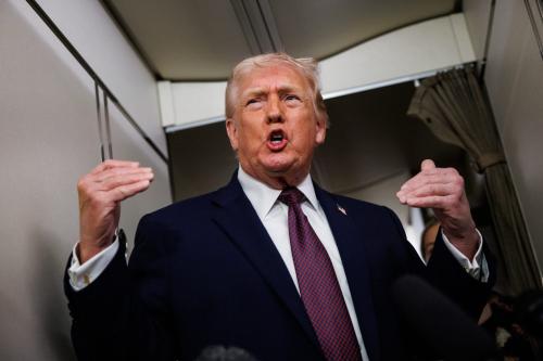 U.S. President Donald Trump takes questions from the members of the press aboard Air Force One on January 11, 2026 en route back to the White House from Palm Beach, Florida.
