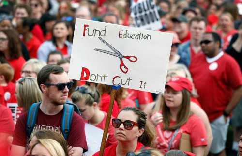 Kentucky Public school teachers rally for a "day of action" at the Kentucky State Capitol to try to pressure legislators to override Kentucky Governor Matt Bevin's recent veto of the state's tax and budget bills on April 13, 2018 in Frankfort, Kentucky. The teachers also oppose a controversial pension reform bill which Gov. Bevin signed into law. Bill Pugliano/Getty Images