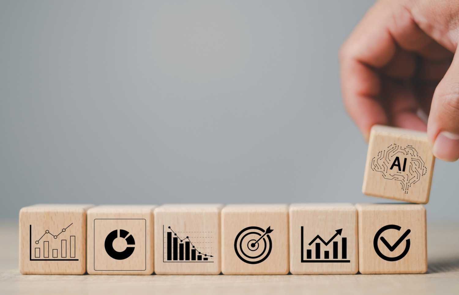 A stack of counting blocks with a new block labeled "AI" being added