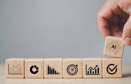 A stack of counting blocks with a new block labeled "AI" being added