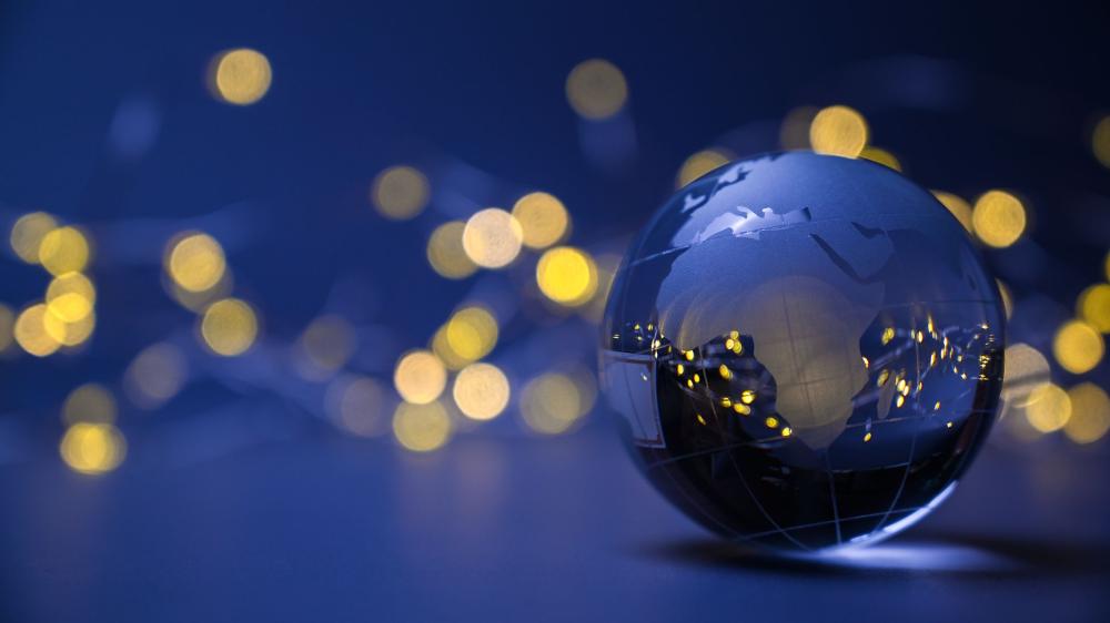 A glass globe focused on Africa, with fuzzy lights in the background
