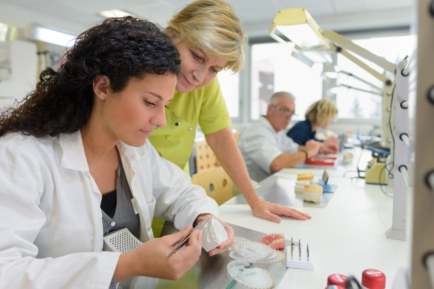 young female trainee working in a prosthetics laboratory