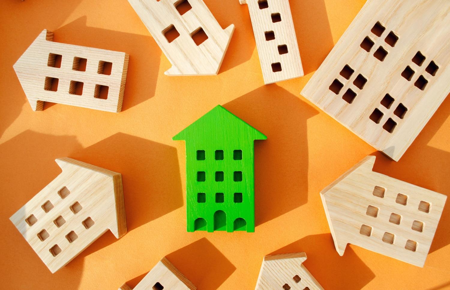 Blocks shaped like houses on an orange background.