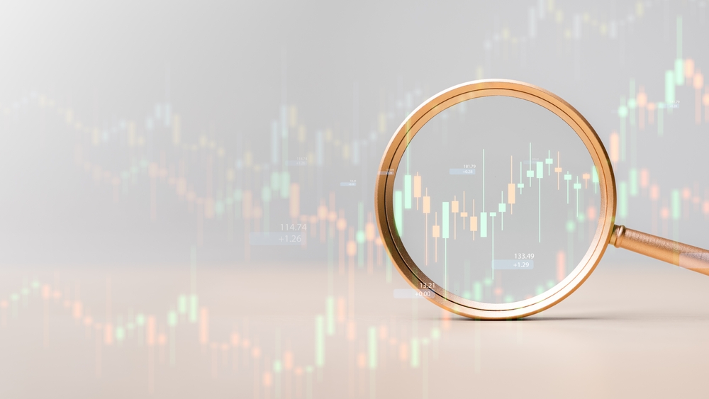 An illustration of a magnifying glass in front of a chart.