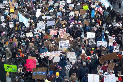 MINNEAPOLIS, MINNESOTA - JANUARY 25: Demonstrators march through downtown protesting ICE operations and the death of Renee Good and Alex Pretti on January 25, 2026 in Minneapolis, Minnesota. Pretti, an ICU nurse at a VA medical center, died yesterday after being shot multiple times during a brief altercation with border patrol agents in the Eat Street district of Minneapolis. Good was killed by an ICE agent on January 7. (Photo by Scott Olson/Getty Images)