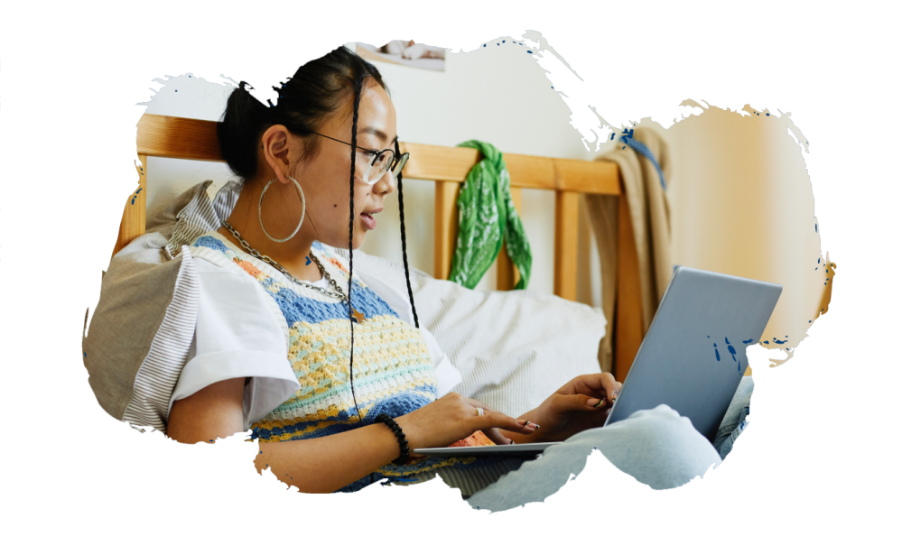 A teen girl uses a laptop