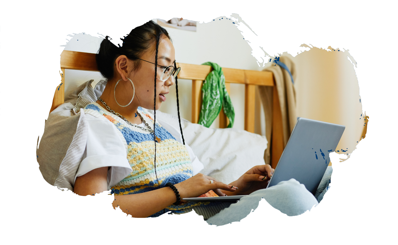 A teen girl uses a laptop