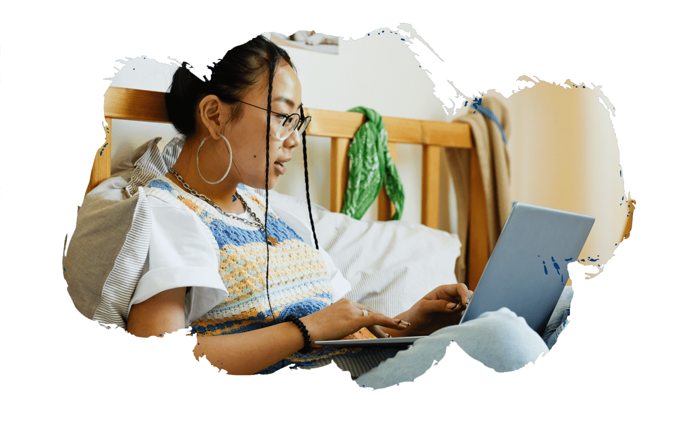 A teen girl uses a laptop