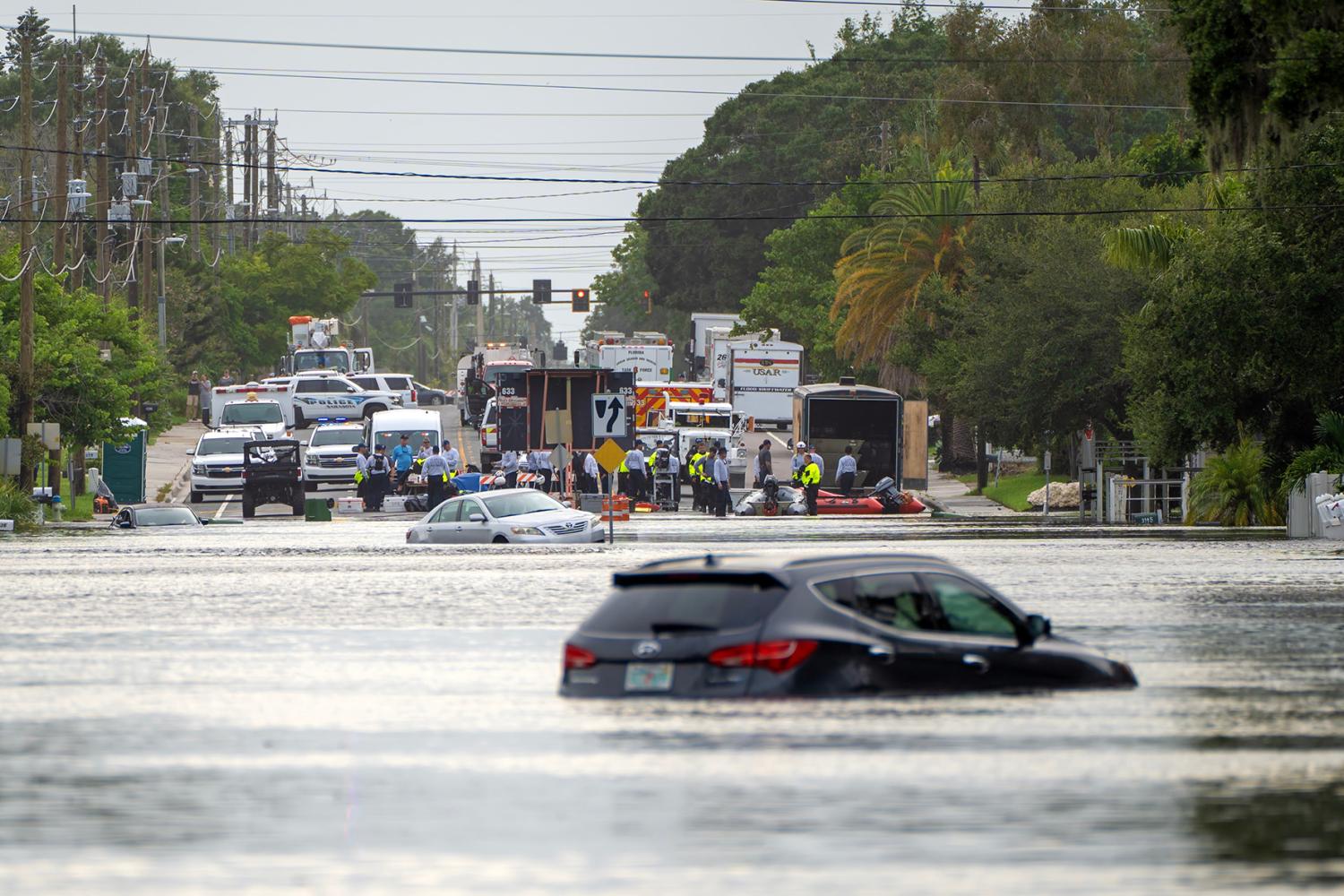 Rescue operation after hurricane Debby flooding in Sarasota, Florida. Emergency response rescue workers on flooded road. Aftermath of natural disaster. Sarasota, USA - August 7, 2024.