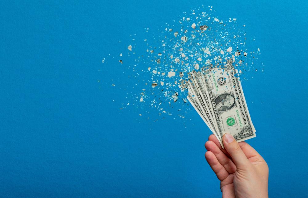 Illustration of dollar bills disintegrating.