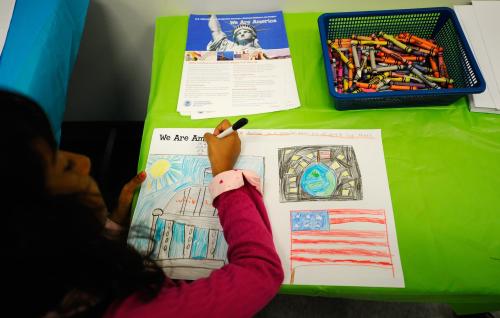 LOS ANGELES, CA - AUGUST 19: Thasuni Bandara, 8, from Sri Lanka, takes part in U.S. Citizenship and Immigration Services commissioned art project for children across the United States before taking the Oath of Allegiance during a citizenship ceremony on August 19, 2010 in Los Angeles, California. During the ceremony 143 people, including 30 area children under the age of 14, received certificates of citizenship. Children were asked to create images depicting their interpretation of the theme, "We Are America." (Photo by Kevork Djansezian/Getty Images)
