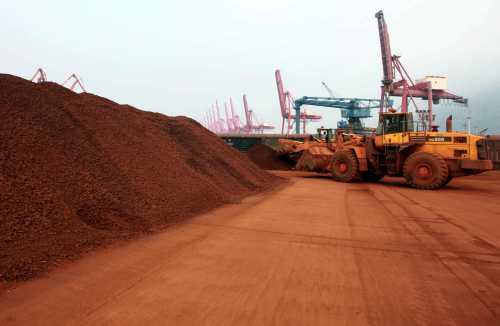 In a picture taken on September 5, 2010 a man driving a front loader shifts soil containing rare earth minerals to be loaded at a port in Lianyungang, east China's Jiangsu province, for export to Japan.