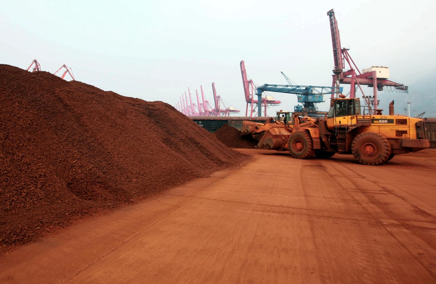 In a picture taken on September 5, 2010 a man driving a front loader shifts soil containing rare earth minerals to be loaded at a port in Lianyungang, east China's Jiangsu province, for export to Japan.