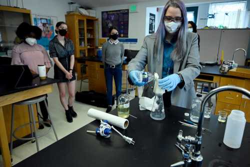 Science teacher Rebecca Bushway demonstrates a low-cost, student-developed water filter at Barrie Middle and Upper School in Silver Spring, Md., on April 21, 2022. During the pandemic, Bushway’s students used 3D printing and chemistry to design the $1 biodegradable prototype to remove lead from faucets.