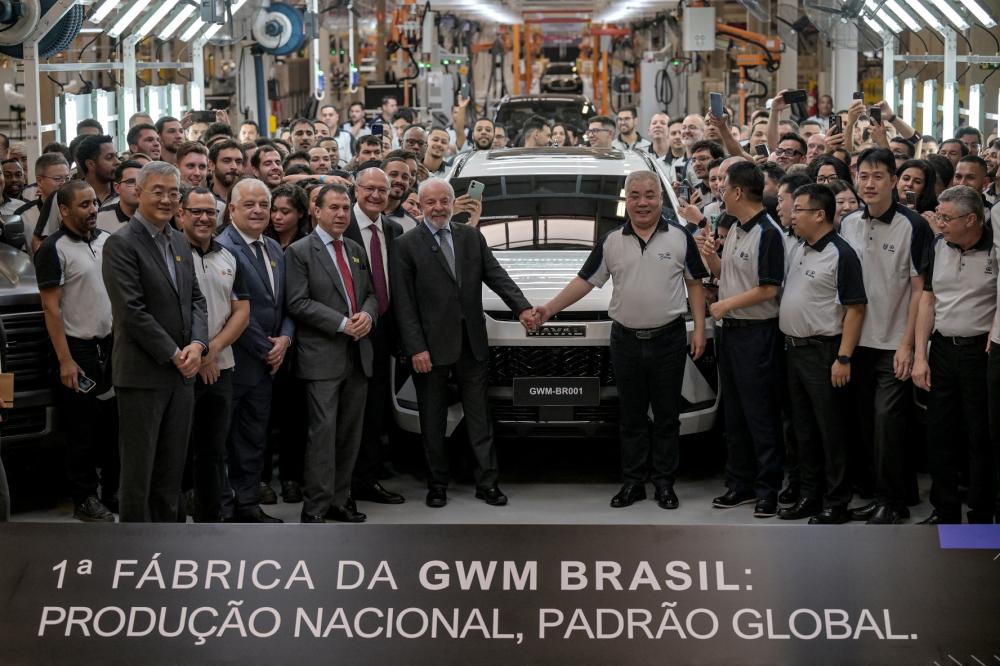 Brazil's President Luiz Inacio Lula da Silva (C-L) and China's Great Wall Motor (GWM) CEO Mu Feng (C-R) pose for a photo during the inauguration of the GWM automobile factory in Iracemapolis, Sao Paulo state, Brazil on August 15, 2025.
