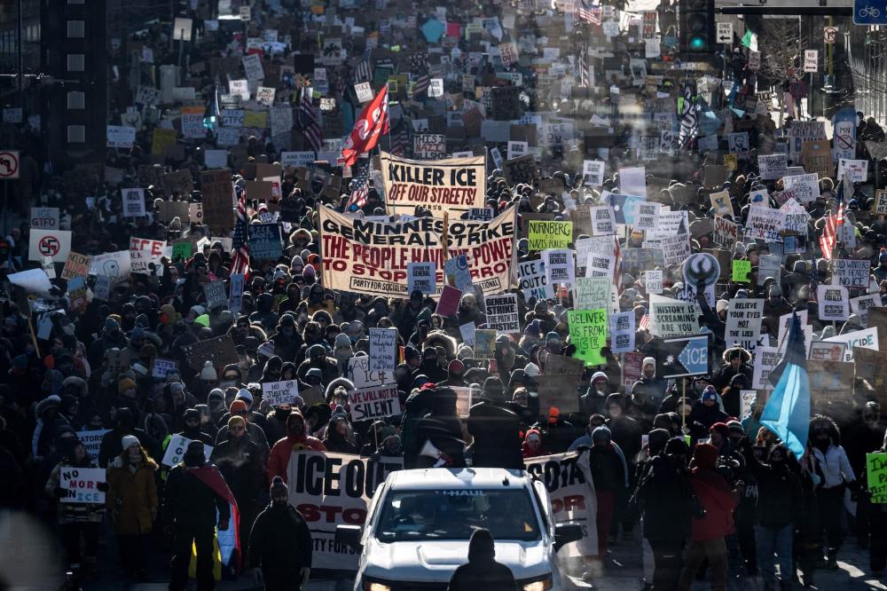 Protesters against Immigration and Customs Enforcement (ICE) march through the streets of downtown Minneapolis, Minnesota, on January 25, 2026. On January 24, federal agents shot dead U.S. citizen Alex Pretti, a 37-year-old ICU nurse, while scuffling with him on an icy roadway, less than three weeks after an immigration officer shot and killed Renee Good, also 37, in her car. His killing sparked new protests and impassioned demands by local leaders for the Trump administration to end its operation in the city.