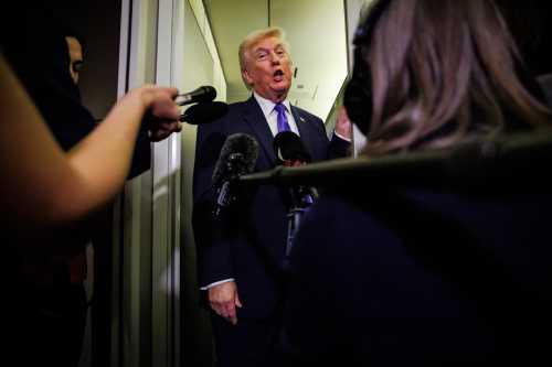 U.S. President Donald Trump gaggles with reporters while aboard Air Force One on Feb. 6, 2026, en route to Palm Beach, Florida. The president is spending the weekend at Mar-a-Lago, his private club.