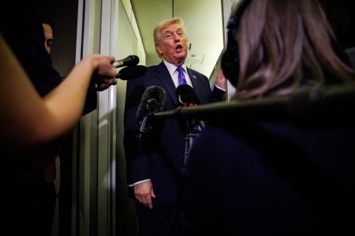 U.S. President Donald Trump gaggles with reporters while aboard Air Force One on Feb. 6, 2026, en route to Palm Beach, Florida. The president is spending the weekend at Mar-a-Lago, his private club.
