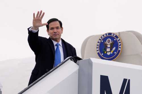 US Secretary of State Marco Rubio waves as he departs Munich International Airport in Munich, southern Germany, on February 15, 2026, after attending the Munich Security Conference (MSC).
