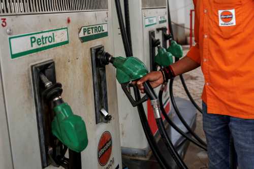 A petrol pump attendant picks up a nozzle to refuel a vehicle at an Indian Oil fuel station in Varanasi on March 10, 2026.