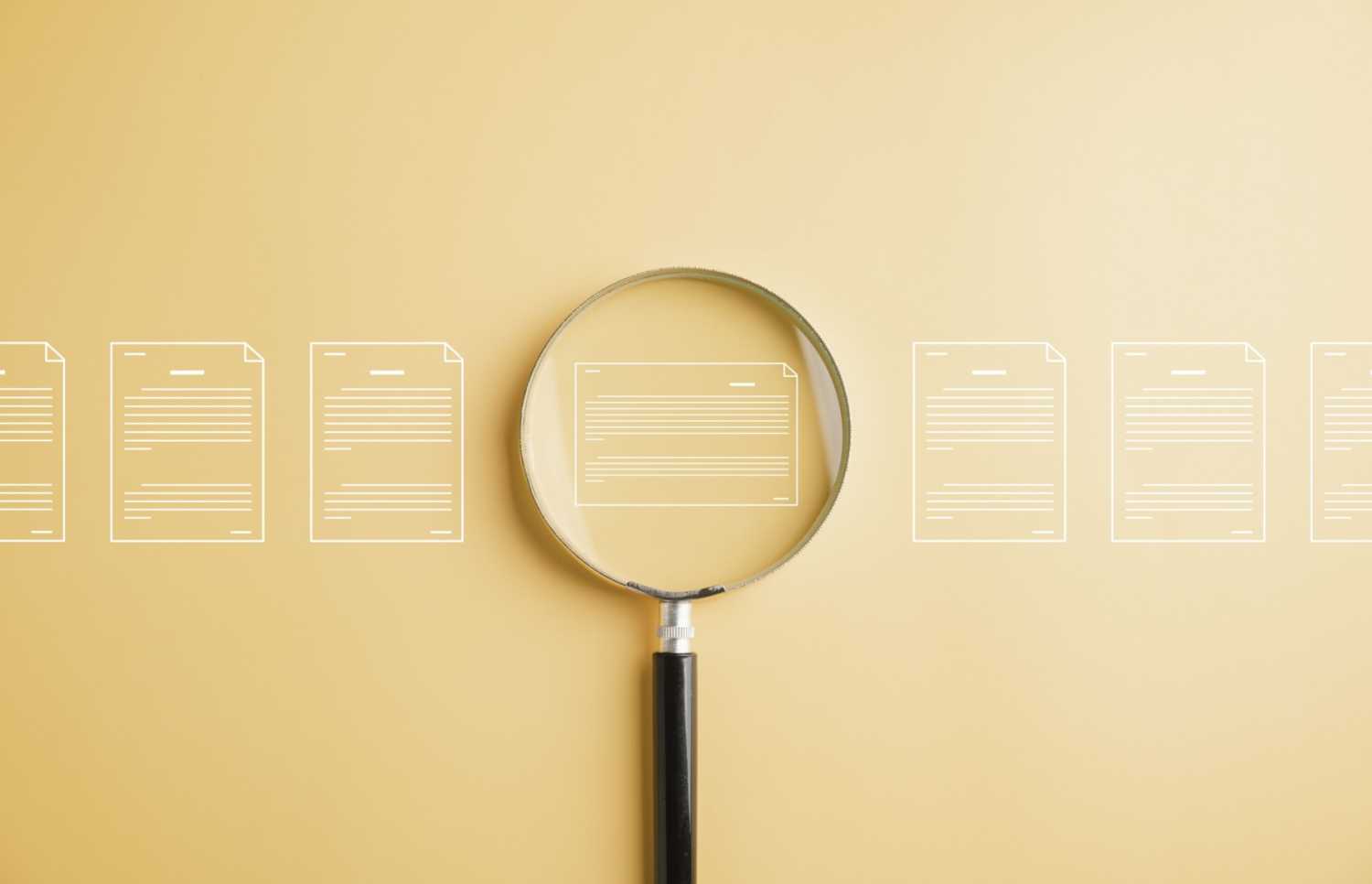 Magnifying glass examining digital files