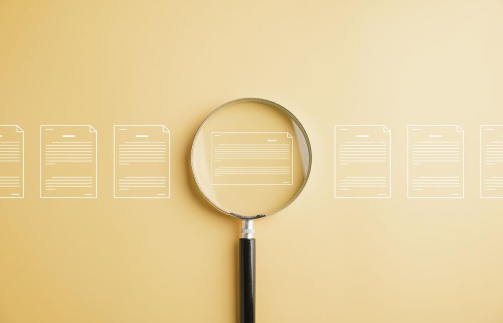 Magnifying glass examining digital files