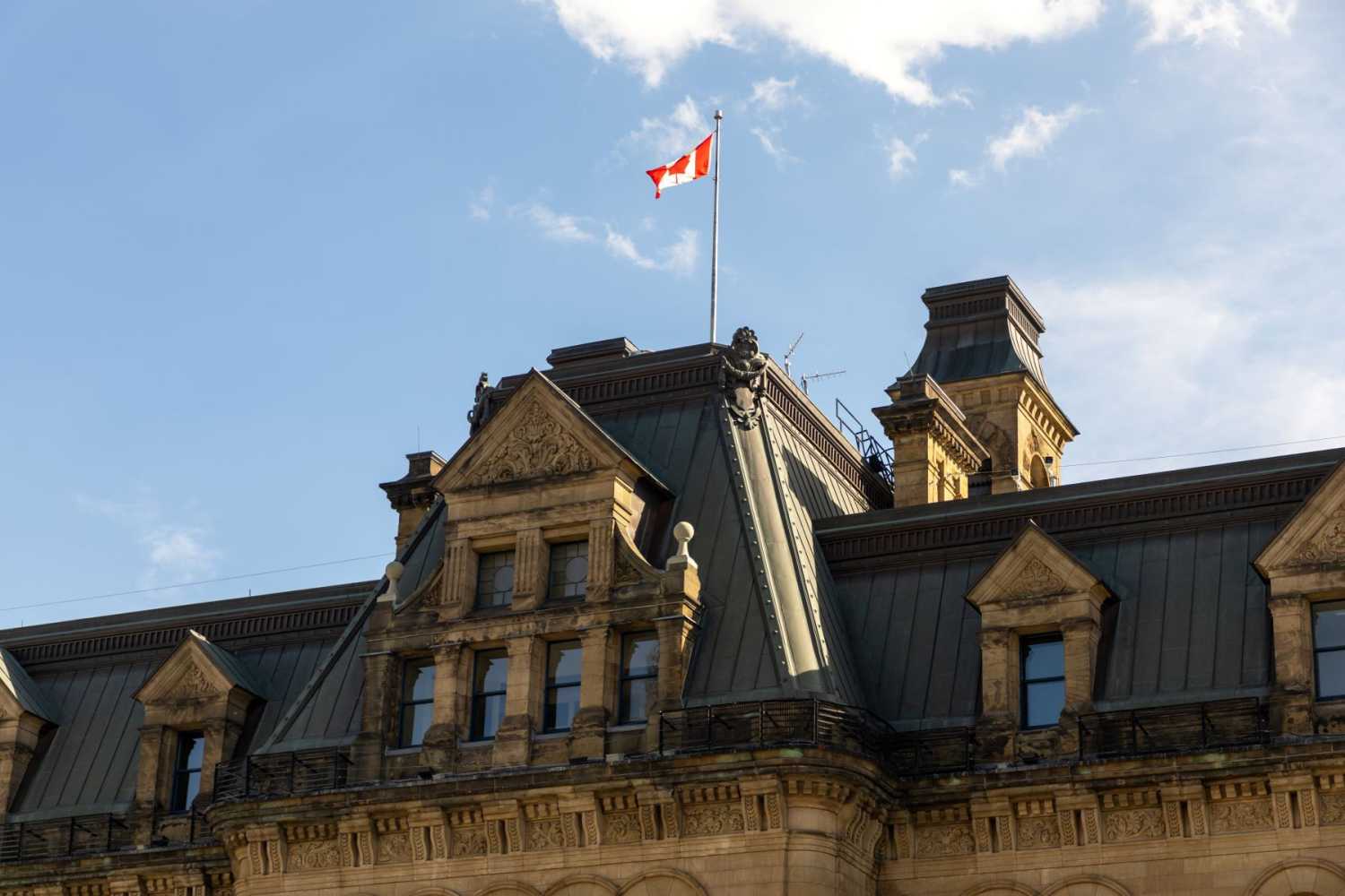 Exterior view of the Canadian prime minister's office building with Canadian flag in Ottawa, Canada