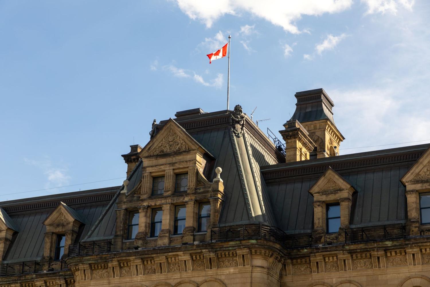 Exterior view of the Canadian prime minister's office building with Canadian flag in Ottawa, Canada