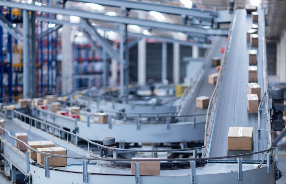 Packages on a conveyor belt in a processing facility.