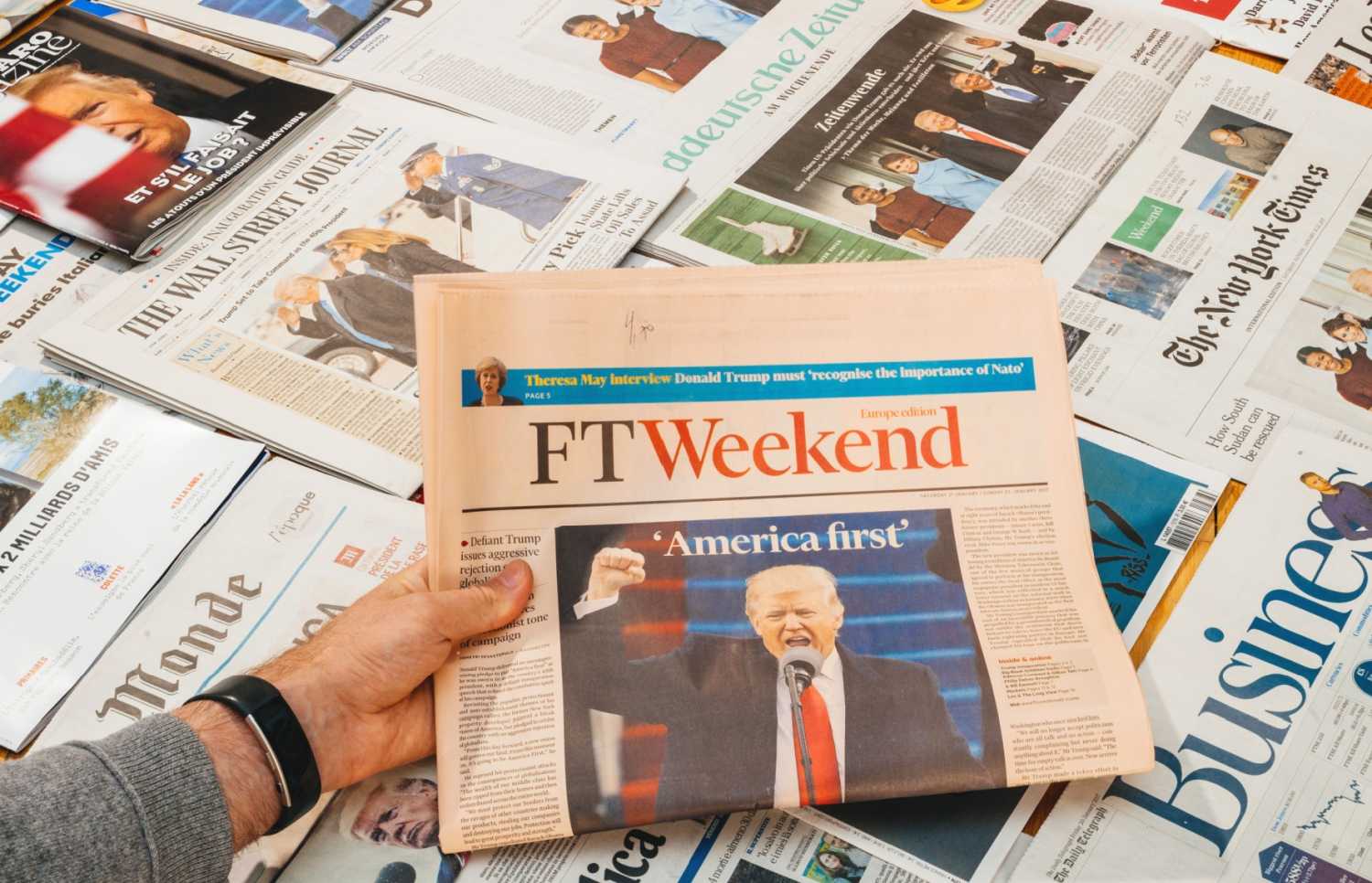 A newspaper with Trump and the words "America First."
