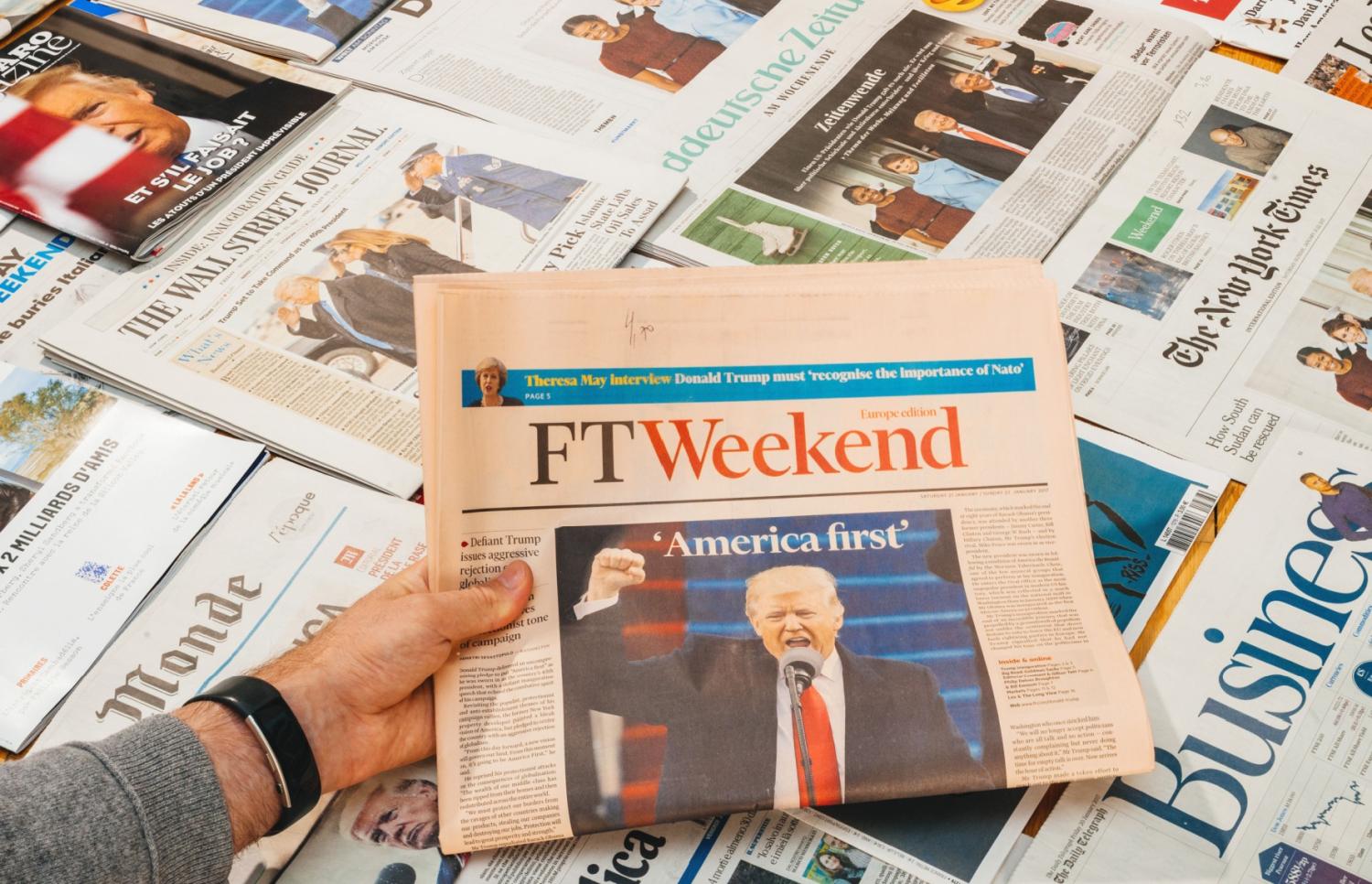 A newspaper with Trump and the words "America First."