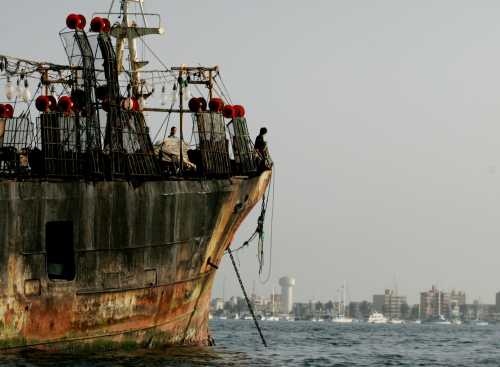 Crewmembers of one of the nine Chinese vessels caught by Peruvian navy wait onboard at their ship in the Peruvian port of Callao, November 24, 2004.