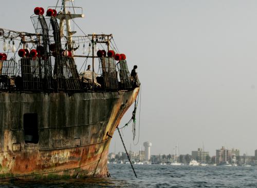 Crewmembers of one of the nine Chinese vessels caught by Peruvian navy wait onboard at their ship in the Peruvian port of Callao, November 24, 2004.