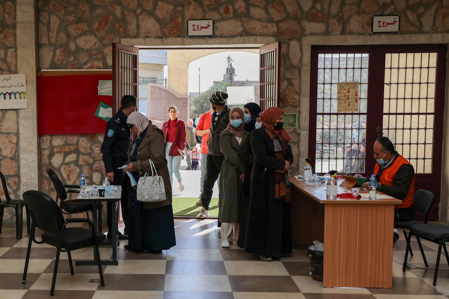 Palestinians are pictured at a polling station during municipal elections in the village of Baitain, east of the occupied West Bank city of Ramallah, on December 11, 2021.