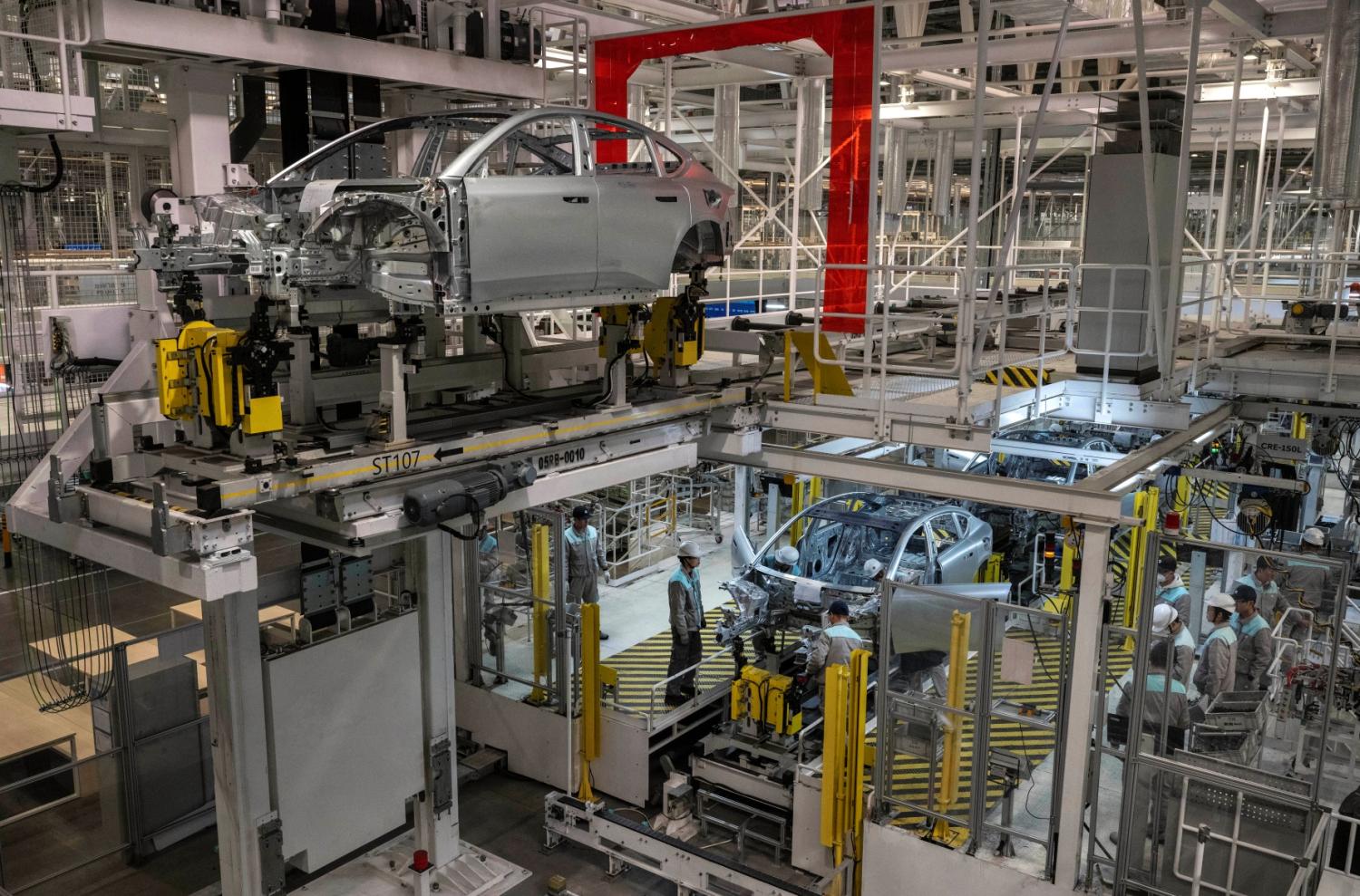 Workers from Chinese electric vehicle (EV) company NIO work on an automated production line at the companys manufacturing hub on January 17, 2025 in Hefei, China.