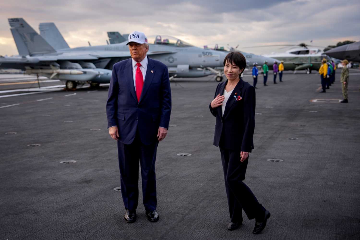 Japanese Prime Minister Sanae Takaichi reacts to a compliment by U.S. President Donald Trump as they arrive aboard USS George Washington at Fleet Activities Yokosuka on October 28, 2025 in Yokosuka, Japan.