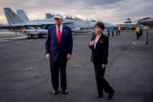 Japanese Prime Minister Sanae Takaichi reacts to a compliment by U.S. President Donald Trump as they arrive aboard USS George Washington at Fleet Activities Yokosuka on October 28, 2025 in Yokosuka, Japan.