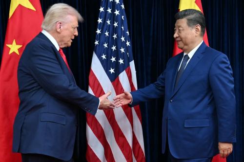 US President Donald Trump (L) extends for a handshake with China's President Xi Jinping as they arrive for talks at the Gimhae Air Base, located next to the Gimhae International Airport in Busan on October 30, 2025.