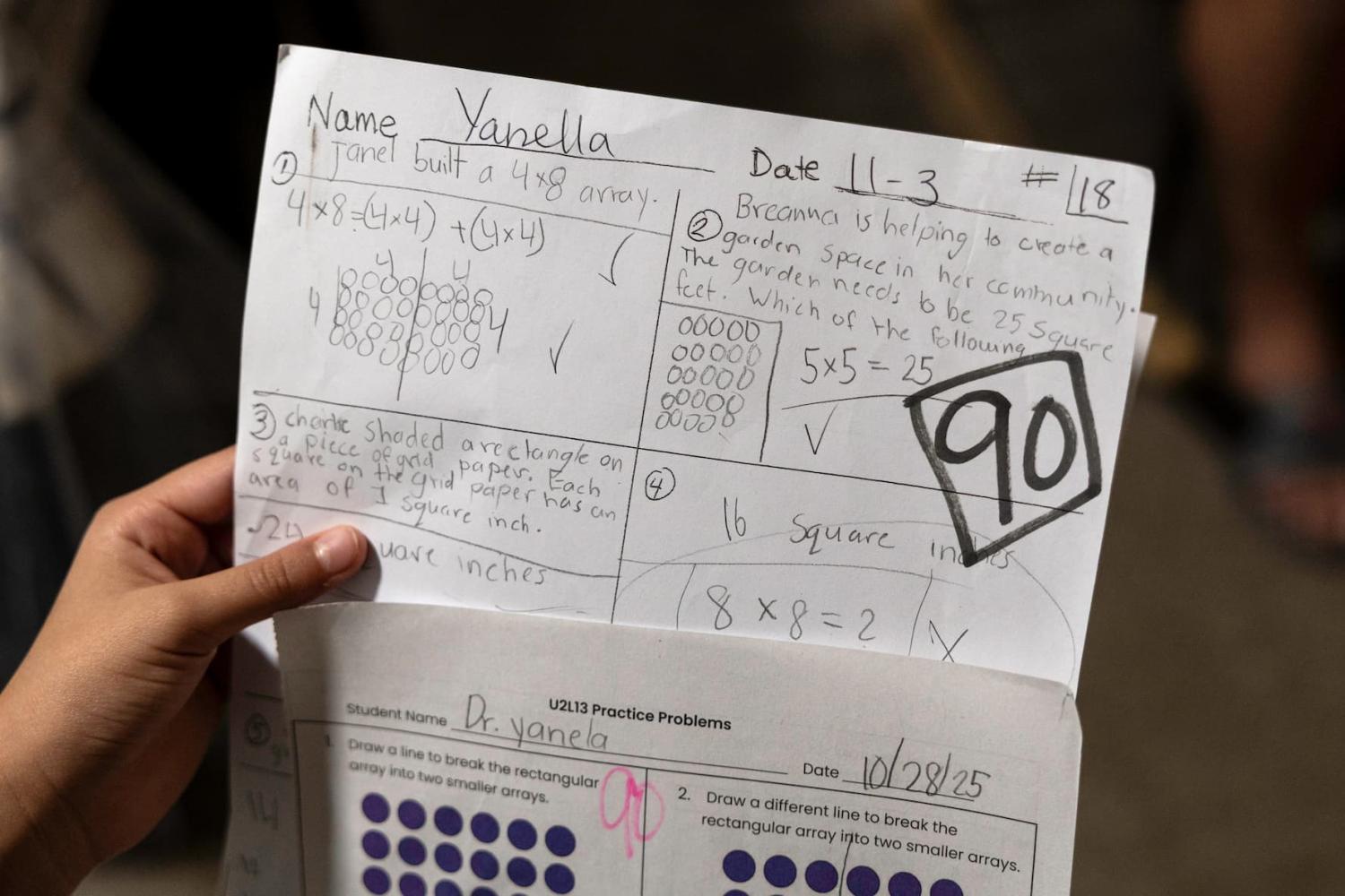UNSPECIFIED, UNITED STATES - NOVEMBER 19 — A 9-year-old girl shows off classwork at her family's apartment on November 19, 2025 at an unspecified location in the United States. Like many of her fellow immigrant students, she stayed home from school earlier in the week due to a Border Patrol operation in the area. Her mother brought her to the U.S. from Honduras in 2018, crossing the Rio Grande from Mexico to McAllen, Texas. They were later released to pursue their asylum process in U.S. immigration court.