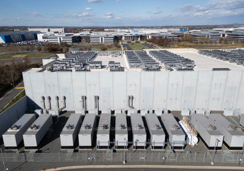 An aerial view shows cooling vent fans on the roof next to generators on the lower level of a Digital Realty data center in Ashburn, Virginia on November 12, 2025. Data centers are the physical infrastructure that make our digital lives possible, yet most people have never seen one up close or understand how they operate. Roughly 12,000 data centers are in operation in the world, with about half in the US, according to Cloudscene, a data center directory.