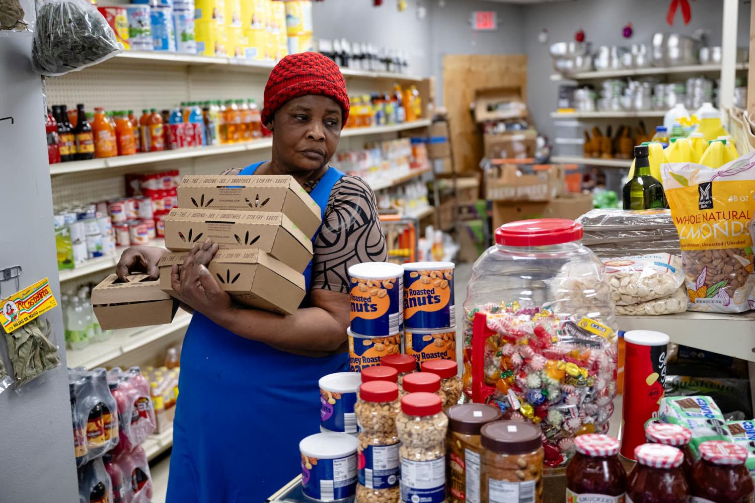 SPRINGFIELD, OHIO - FEBRUARY 3: Bamilia Delcine Olistin restocks product at Bon Samaritain Grocery, a Haitian-owned grocery, on February 3, 2026 in Springfield, Ohio. A federal judge issued a temporary stay blocking the Trump administration's attempt to strip Temporary Protected Status (TPS) for Haitian immigrants, but Haitian TPS beneficiaries and residents of Springfield continue to face uncertainty over their protected status.