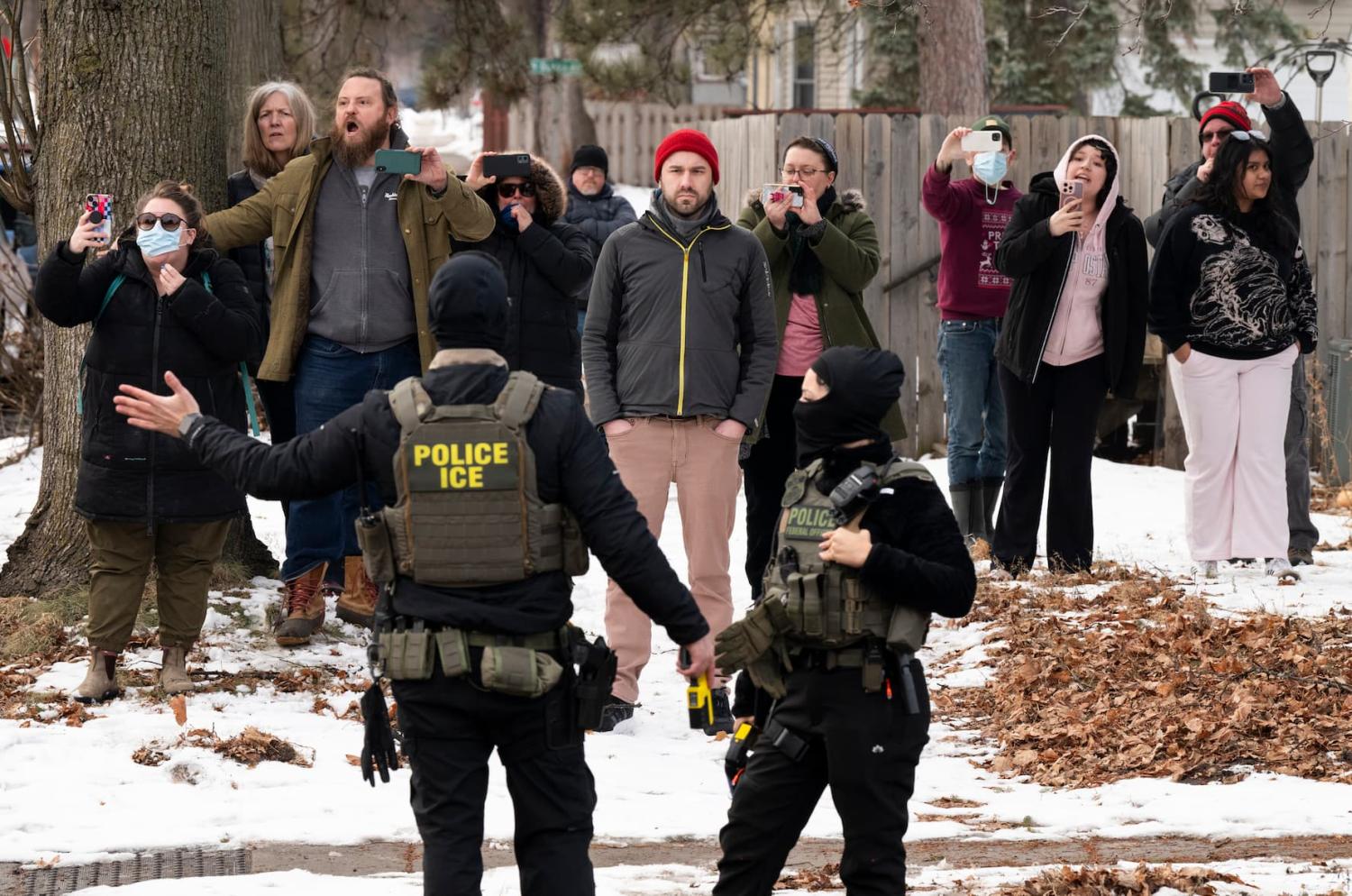 MINNEAPOLIS, MINNESOTA - FEBRUARY 05: Observers film ICE agents as they hold a perimeter after one of their vehicles got a flat tire on Penn Avenue on February 5, 2026 in Minneapolis, Minnesota. Protests continue calling for an end to immigration raids in the Twin cities which have already resulted in the fatal shooting deaths of Alex Pretti, a VA nurse, and Renee Good, a mother of three, by federal agents.