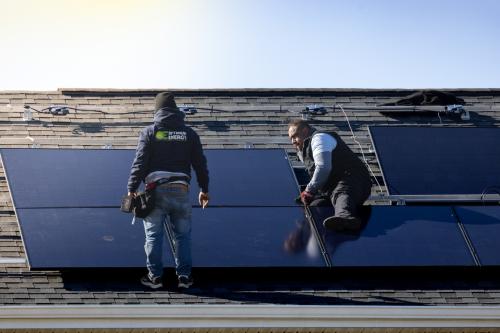 A team of solar panel installers work to install a new solar panel array before the Federal Tax Credit Expires.