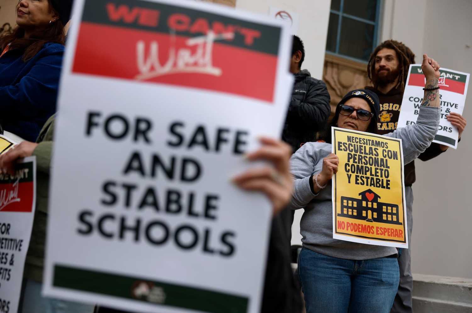 SAN FRANCISCO, CALIFORNIA - FEBRUARY 09: Teachers hold signs on the steps of Mission High School as San Francisco Unified School District teachers picket on the first day of a citywide teachers' strike on February 09, 2026 in San Francisco, California. Nearly 6,000 educators in the San Francisco Unified School District walked off the job Monday, the city’s first teachers’ strike in almost 50 years, after contract talks collapsed over wages, health benefits and staffing, leaving all 120 district schools closed as negotiations continue.