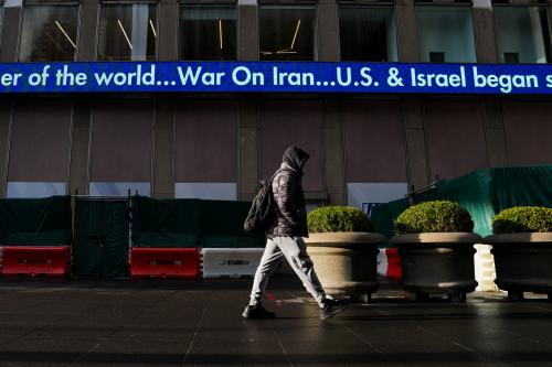 A man walks by the Fox News ticker displaying "War on Iran" on February 28, 2026 in New York, New York.
