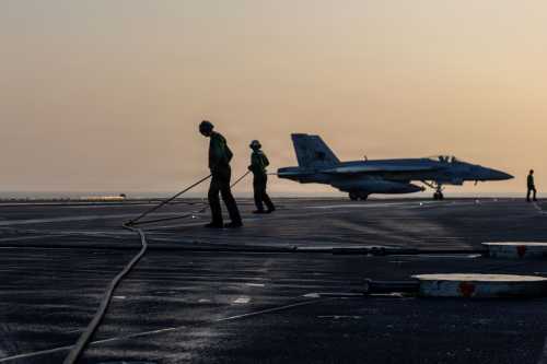 In this U.S. Navy released handout, an F/A-18E Super Hornet, attached to Strike Fighter Squadron (VFA) 14, taxis the flight deck after an arrested landing on Nimitz-class aircraft carrier USS Abraham Lincoln (CVN 72) in support of Operation Epic Fury on March 1, 2026 at sea.
