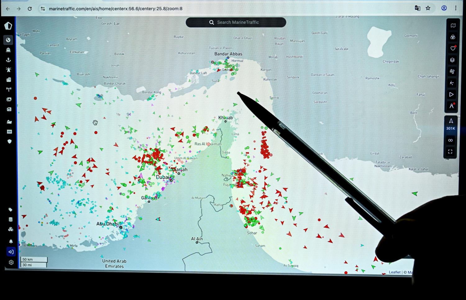 A person points at a page on the Marinetraffic website that shows commercial boats traffic on the edge of the Strait of Hormuz near the Iranian coast, in Paris on March 4, 2026.
