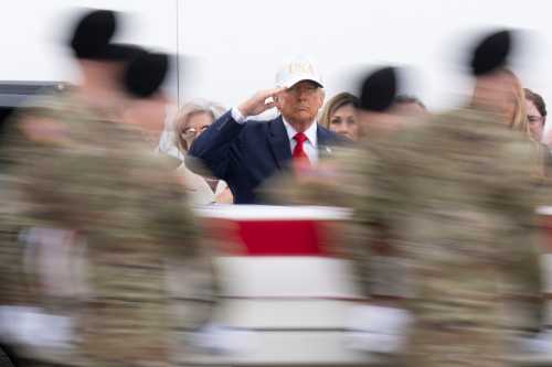 U.S. President Donald Trump salutes as a U.S. Army carry team moves a flag-draped transfer case containing the remains of Sgt. 1st Class Nicole M. Amor at Dover Air Force Base on March 07, 2026 in Dover, Delaware.