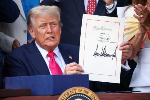 WASHINGTON, DC - JULY 04: U.S. President Donald Trump, joined by Republican lawmakers, signs the One, Big Beautiful Bill Act into law during an Independence Day military family picnic on the South Lawn of the White House on July 04, 2025 in Washington, DC.
