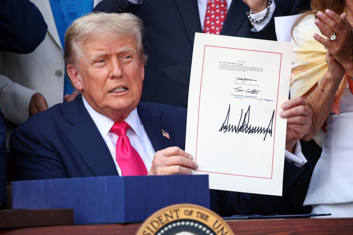WASHINGTON, DC - JULY 04: U.S. President Donald Trump, joined by Republican lawmakers, signs the One, Big Beautiful Bill Act into law during an Independence Day military family picnic on the South Lawn of the White House on July 04, 2025 in Washington, DC.